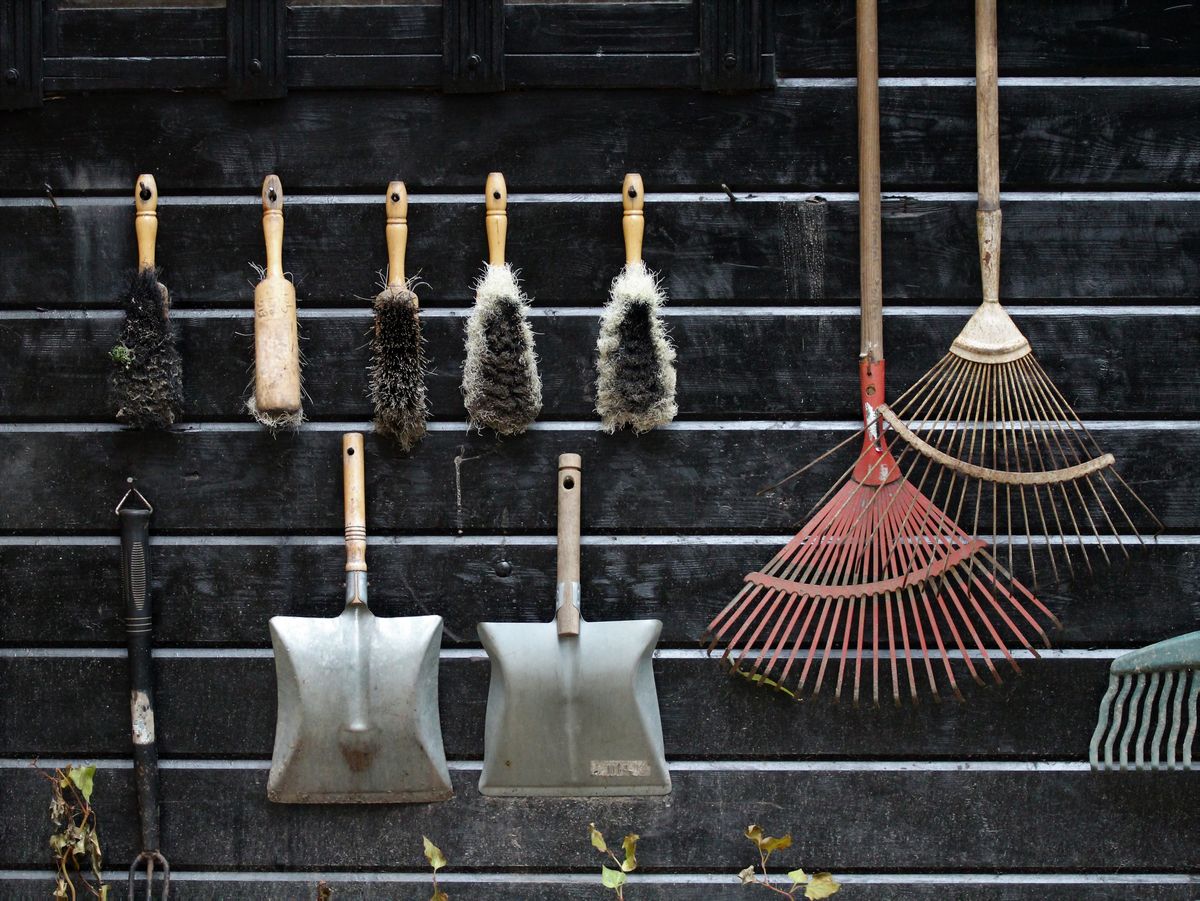 Garden tools hanging on a wooden wall