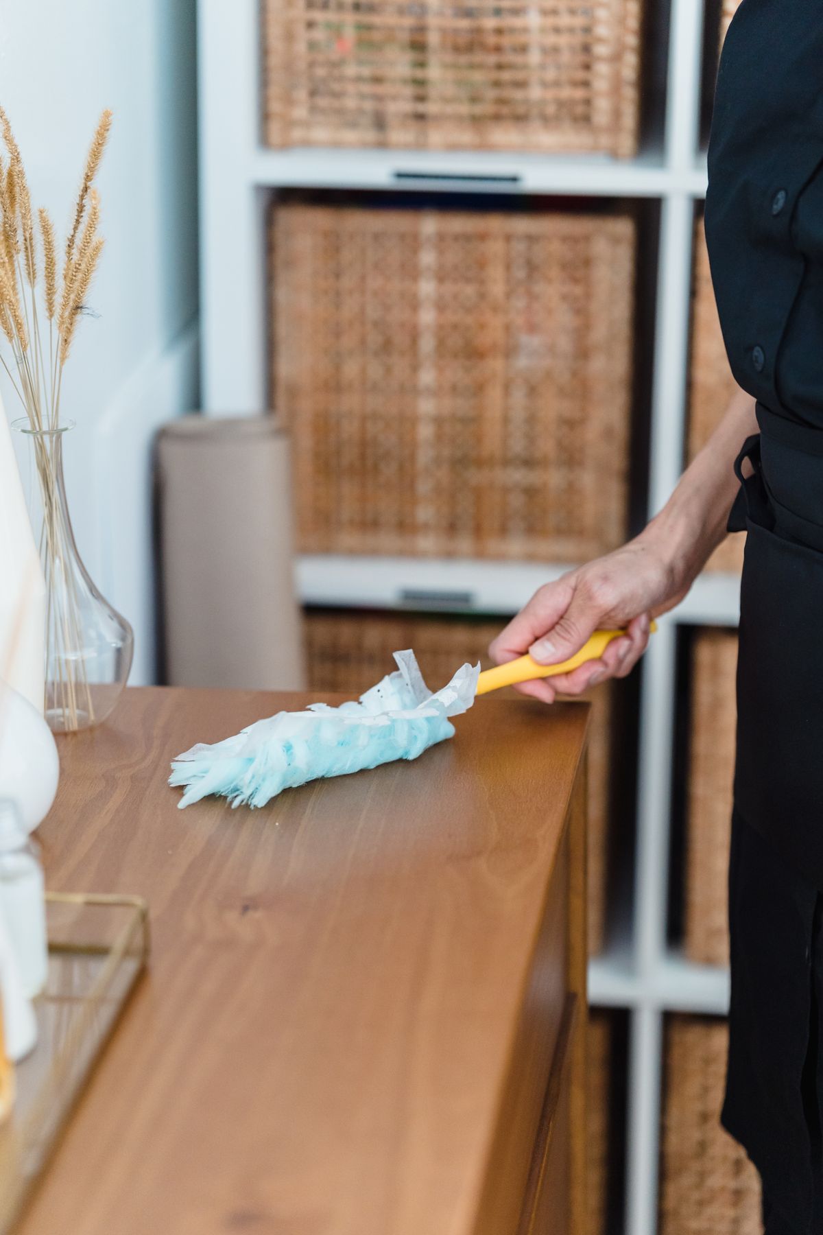 Dusting a wooden cabinet